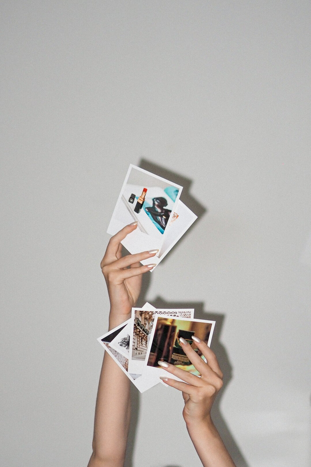 Close-up of hands sorting through printed evidence and photographs